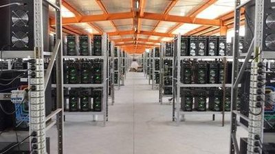 A sprawling mining farm with rows of running miners.